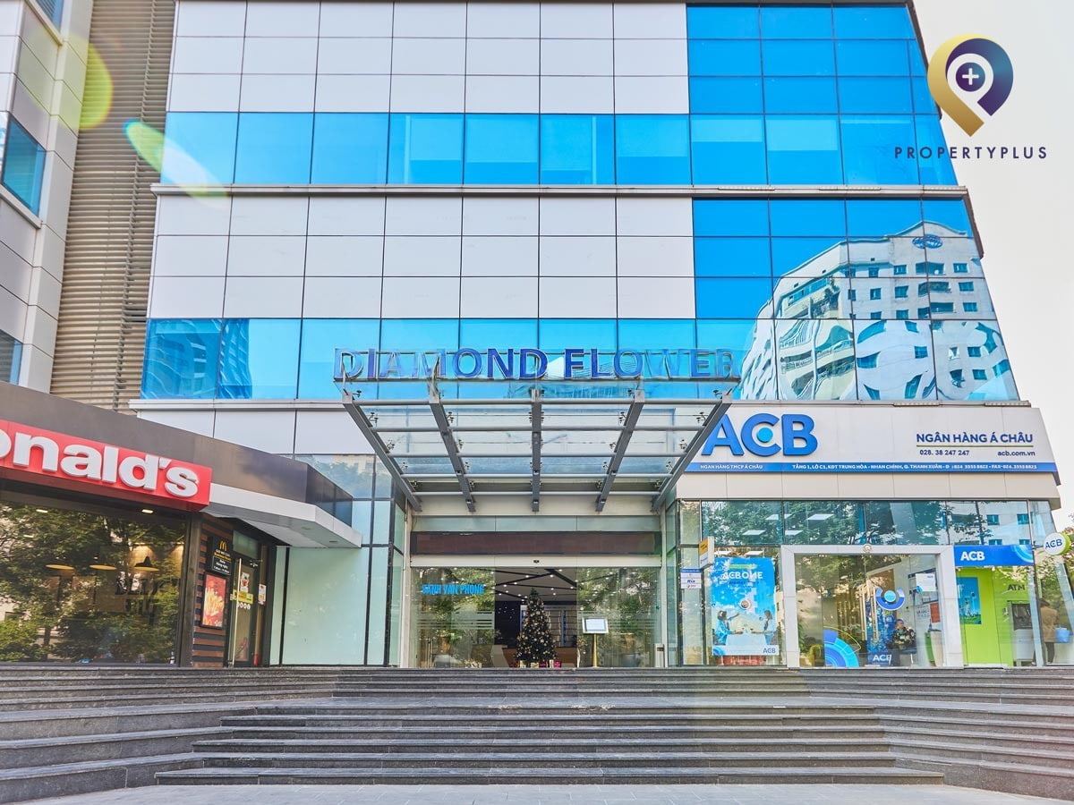 Main entrance of Diamond Flower Tower with modern glass doors and signage
